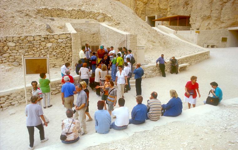 Tourists at a tomb entrance.