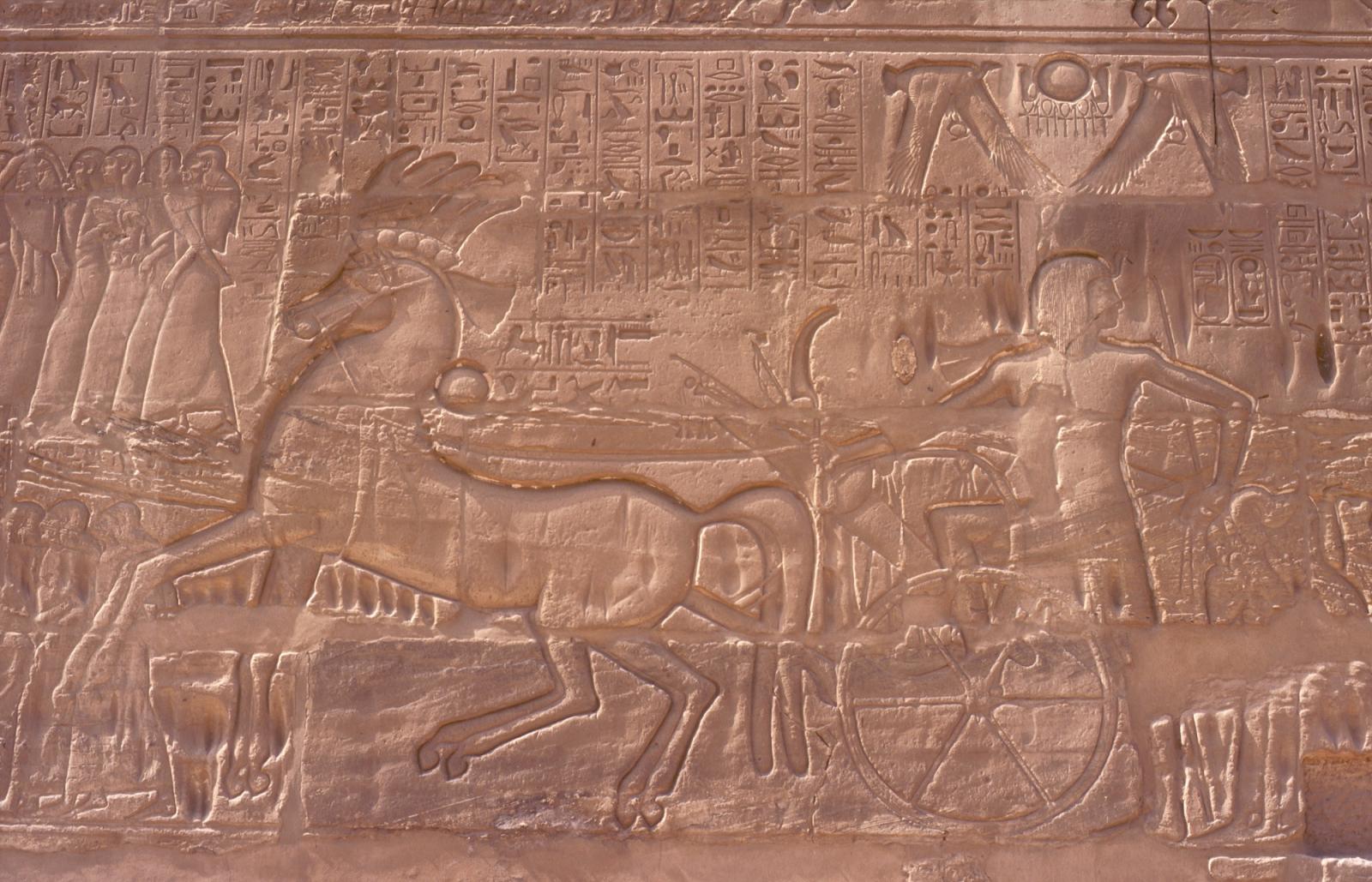 Sety I mounting chariot and leading captives on exterior wall of great hypostyle hall.