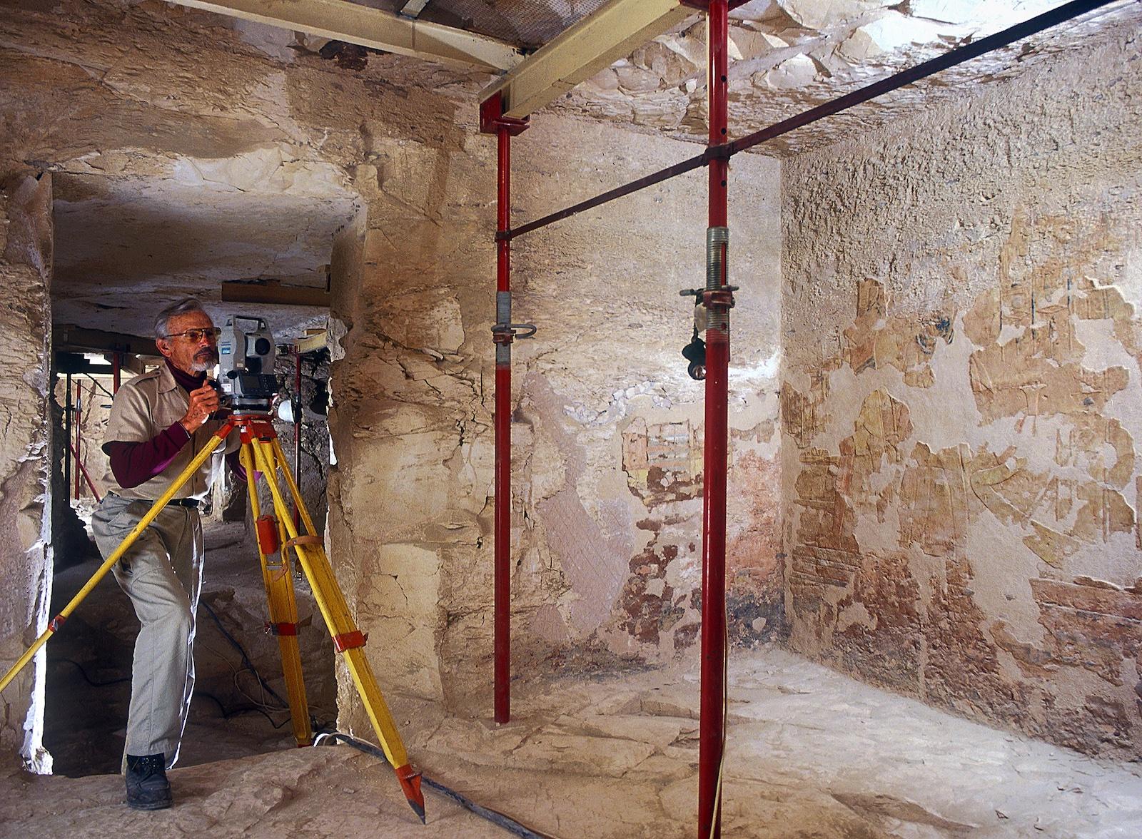 Surveyor David Goodman adding newly cleared features to tomb plan.